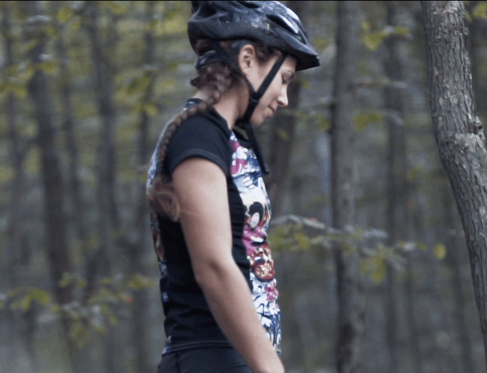 Moxie Tee Jersey Graffiti worn by cyclist in wooded area.